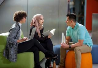 three people having a meeting