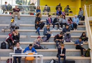 students sitting on oversized steps