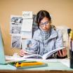 Student studying at desk from a textbook