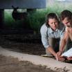 Two researchers taking measurements of soil