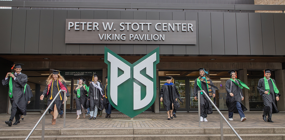 Graduates walking down the steps at Viking Pavilion