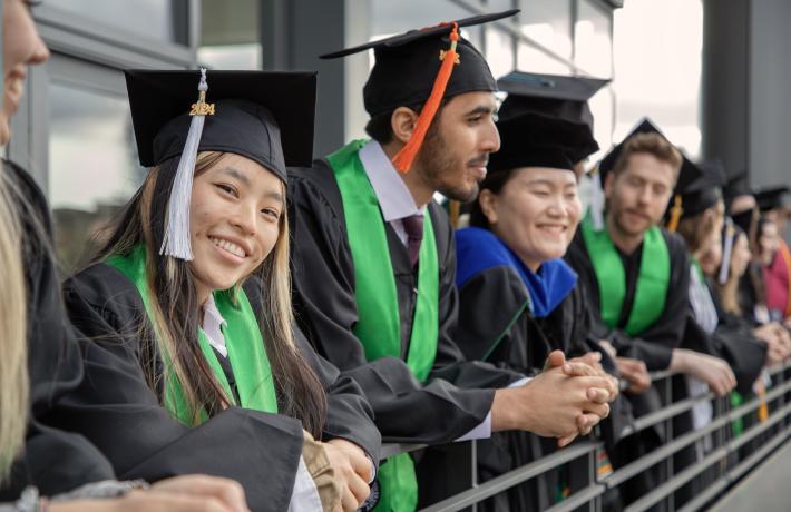 Graduates in regalia celebrating