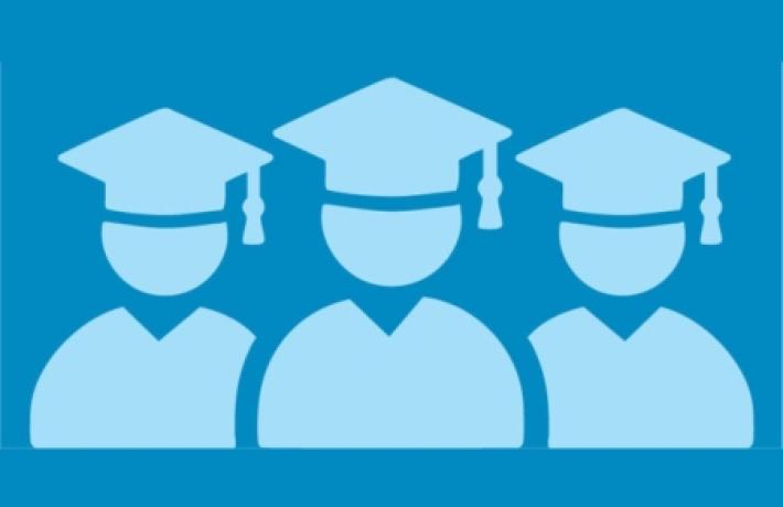 Three graduates in blue caps and gowns