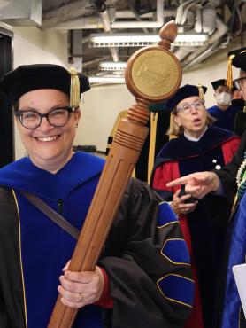 Faculty member carries mace in procession