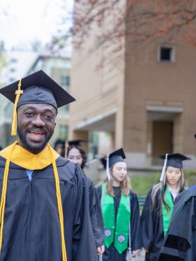 Graduates process in caps and gowns at PSU commencement