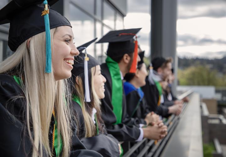PSU graduates assemble in caps and gowns