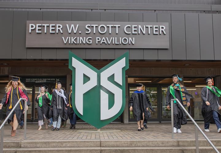 Graduates walking down the steps at Viking Pavilion