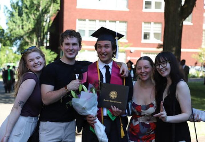 College of Liberal Arts and Sciences graduate poses with friends after the commencement ceremony on the PSU campus