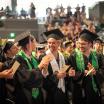 Graduates clapping at commencement ceremony