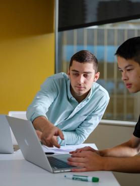 PSU systems science undergraduate students working on a laptop computer