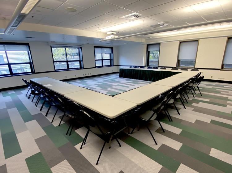 Smith meeting room with U-shaped table and chairs. Windows look out onto SW Broadway.