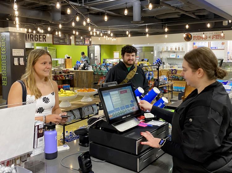 Students purchase lunch at a station in the Smith's Place food court.