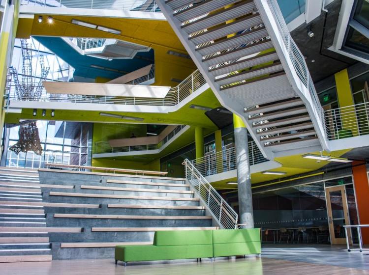 Architectural features of the Karl Miller Center, showing the intersection of the stairs and different colors of each of the floors