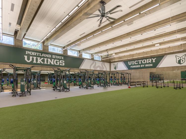 An architectural rendering of the weight room with an indoor gym and fake-grass field