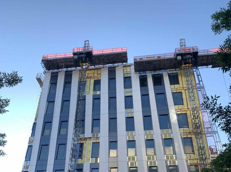 Streetview photo of FMB as it is being constructed with material elevators attached to the incomplete outside wall