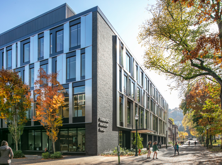 A photo of the newly constructed building from the northwest corner where the brick meets the wall of windows and the building name is displayed