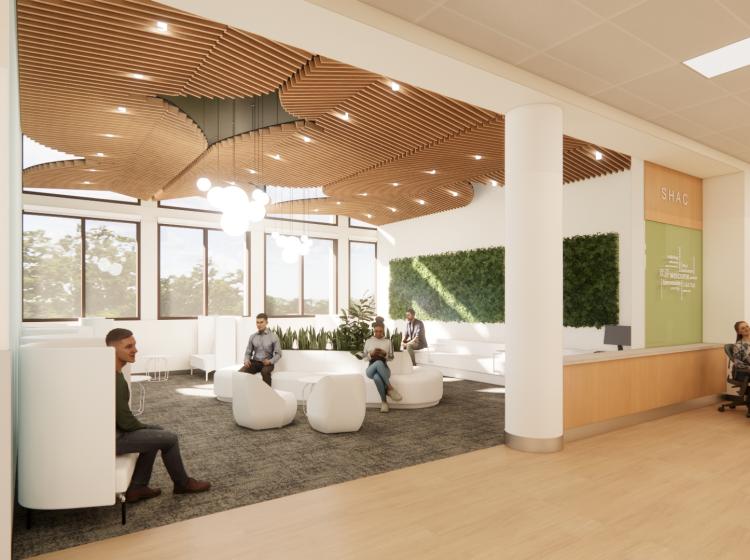 Interior view of main waiting room with people sitting in lounge chairs.