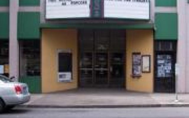 The exterior entrance of Fifth Avenue Cinema showing the entrance doors and the movie marquee