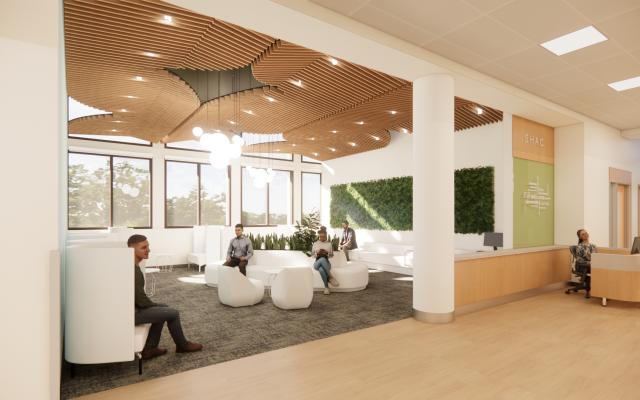 Interior view of main waiting room with people sitting in lounge chairs.