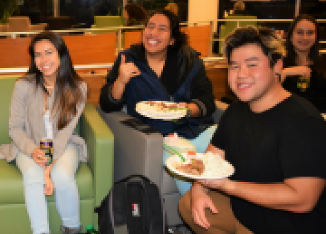 Students eating food at an CRC event