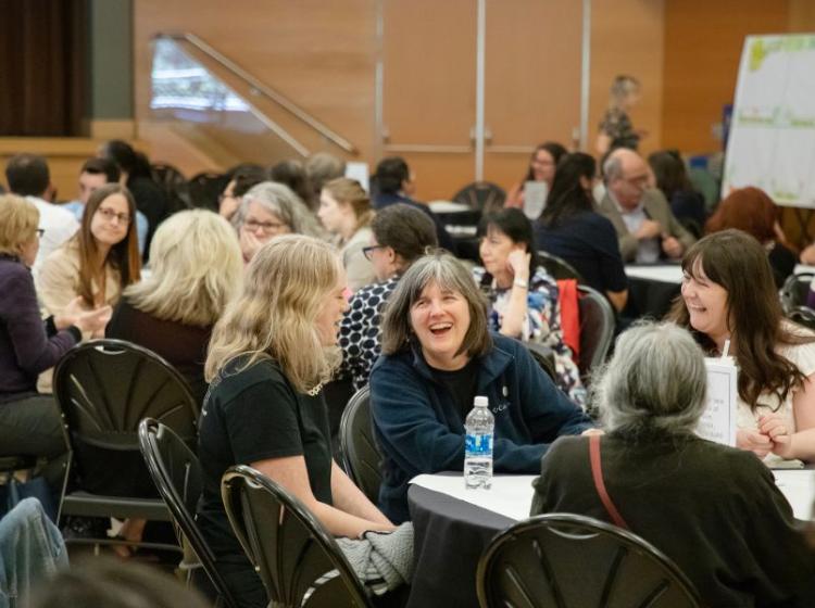 people in conversation at table