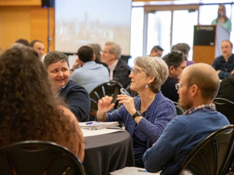 people in conversation at tables