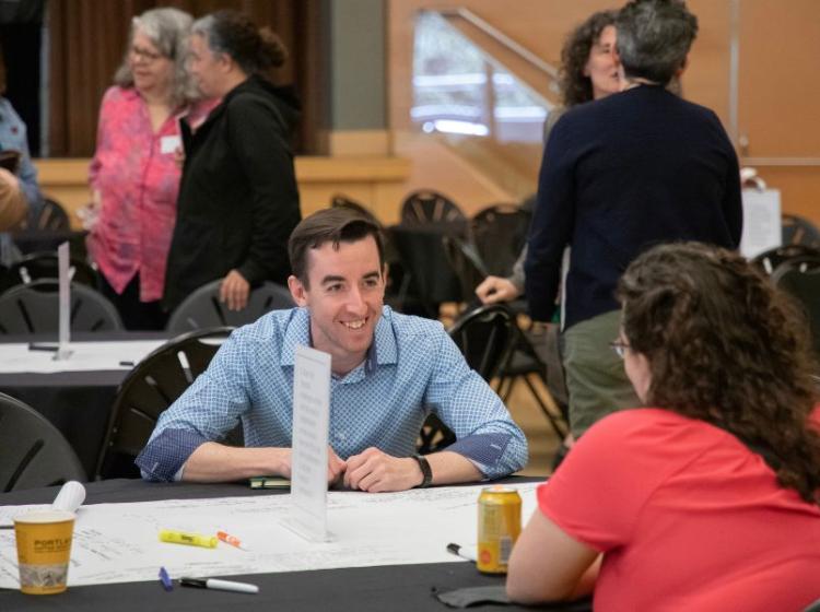 people in conversation at tables