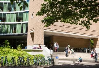 Students exiting the library and walking down the front steps