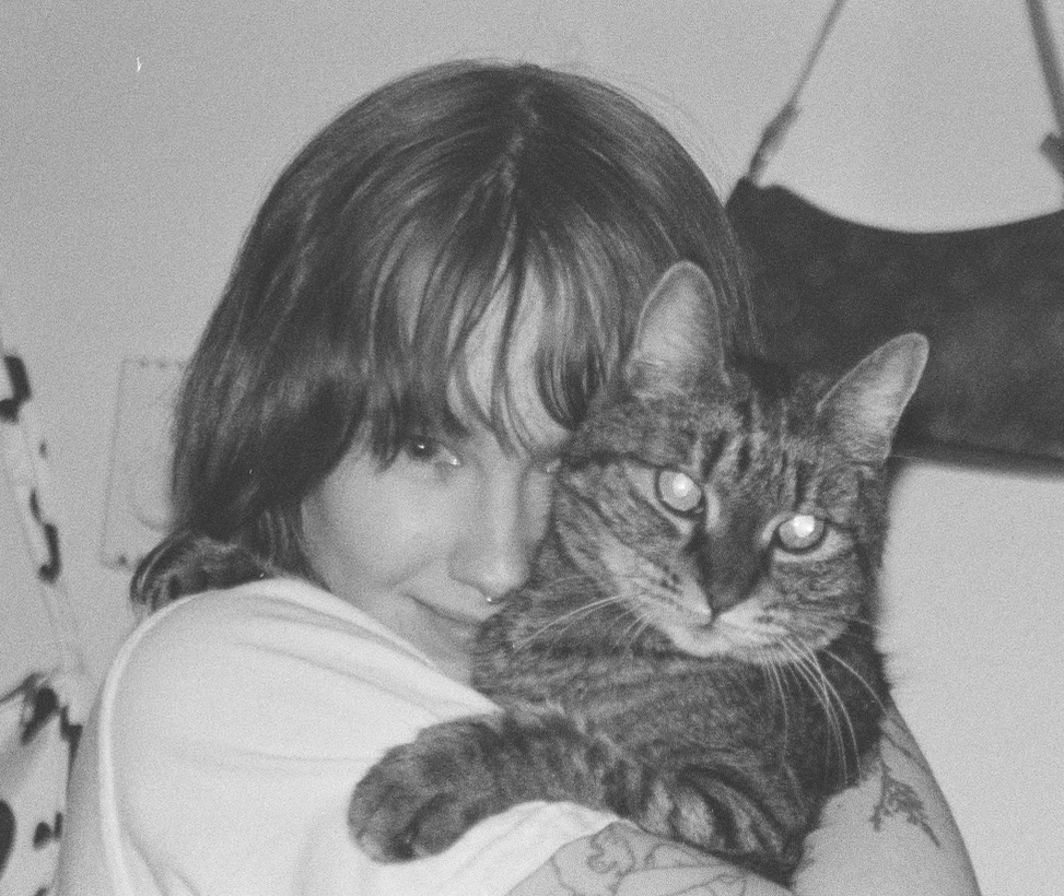 Black and white photo of Hanna holding a tabby cat