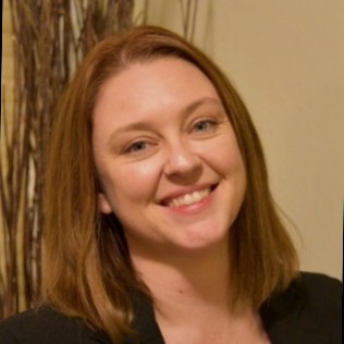 Photo of Andrea Mecheli. Andrea has light brown hair and is wearing a black shirt.