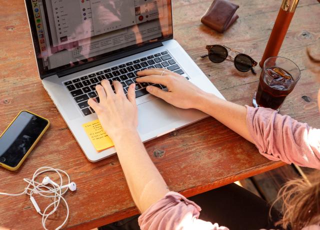 A person typing on a laptop