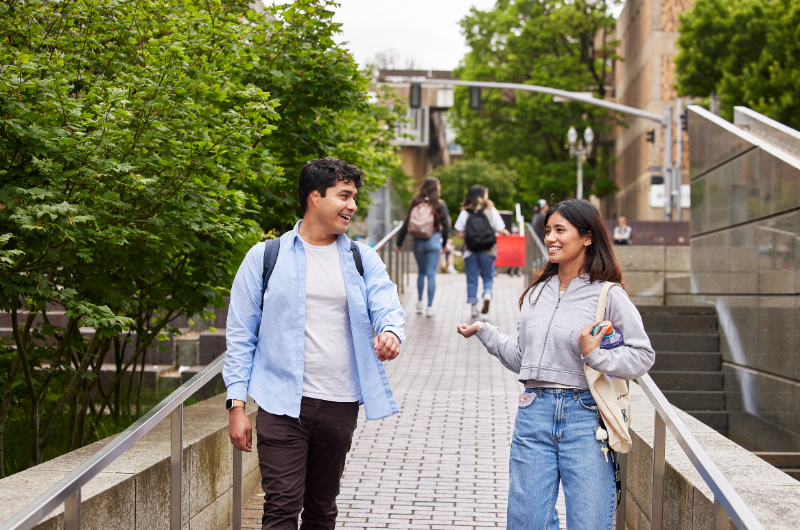 Two students walking in PSU's Urban Plaza