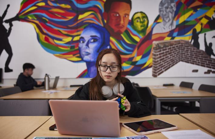 Student on computer in PIAAA Student Center