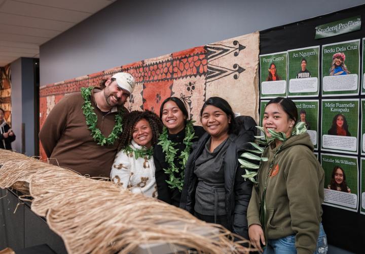 Students pose during Oceania exhibit as part of class project