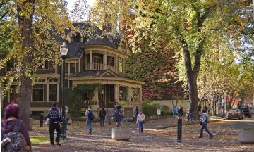 People walking on the Park Blocks outside Simon Benson House