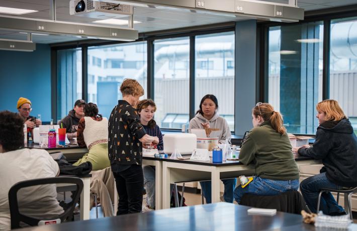 Students collaborating on a project around lab tables in a classroom in Vernier Science Center