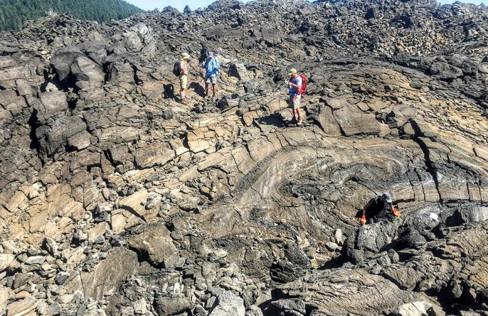Students looking at lava rocks