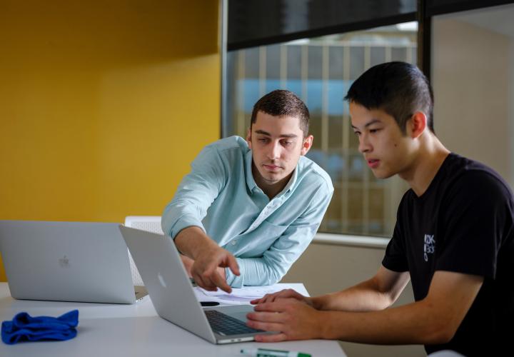 Two students on laptop