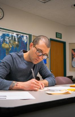 Student filling out tags that represent migrants crossing the border