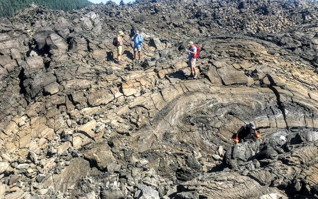 Students on lava rocks in field trip