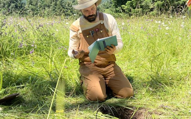 Student analyzing soil samples at field site
