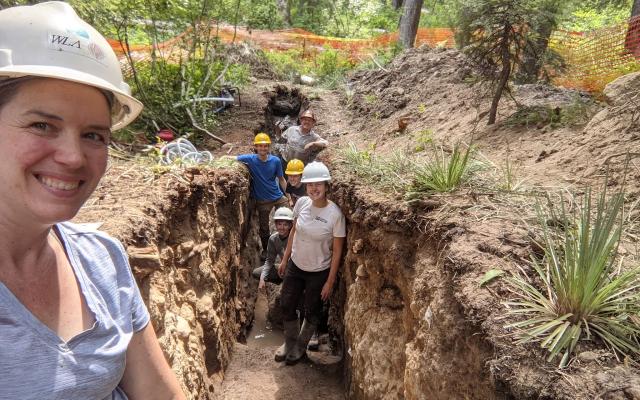 Professor and students in trench