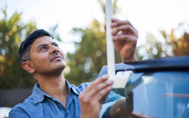 Researcher measuring urban heat with temperature monitor
