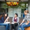 Three female students in a discussion.