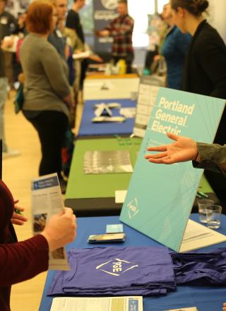 Portland General Electric representative talking to PSU student