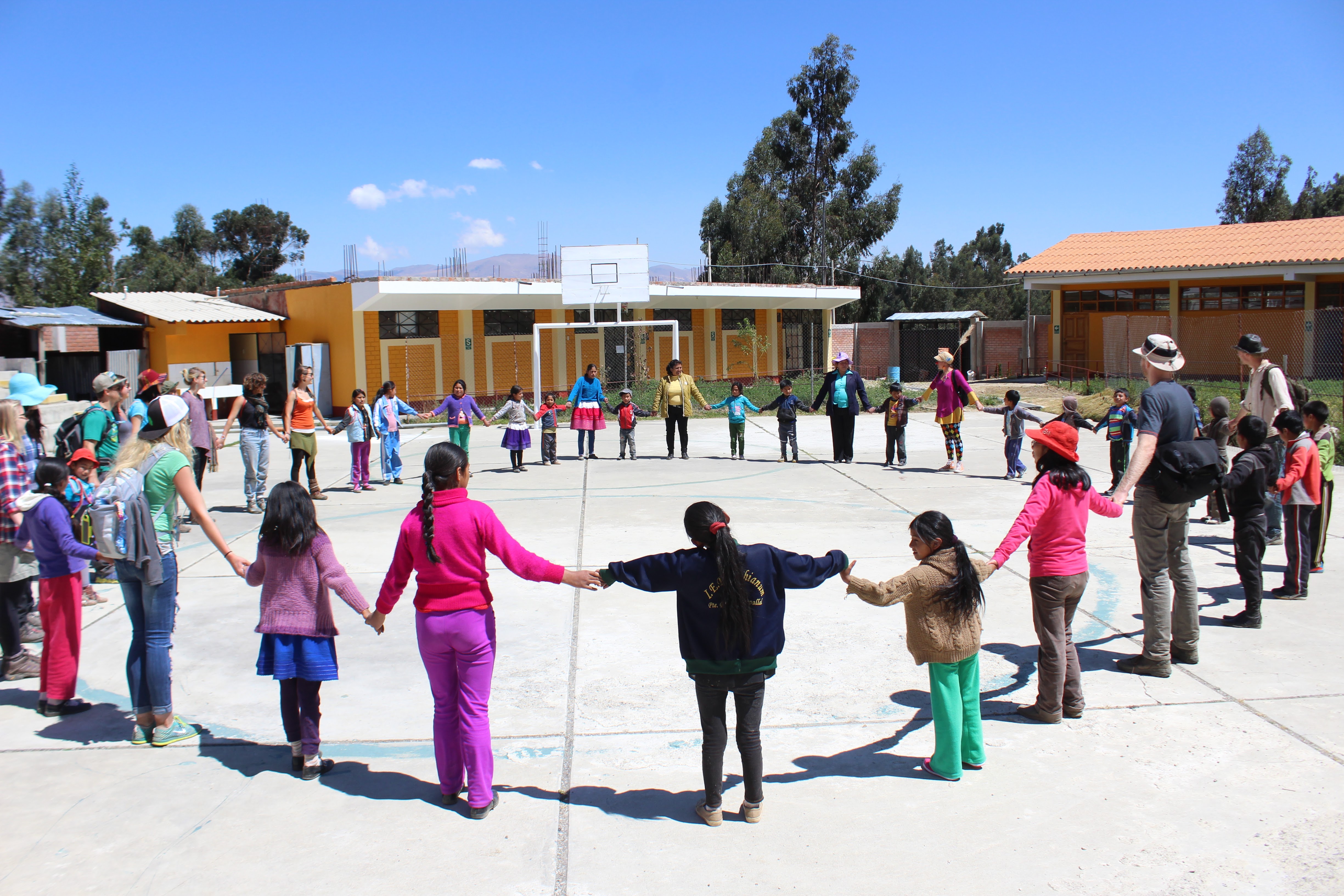 School students in Peru holding hands in a circle