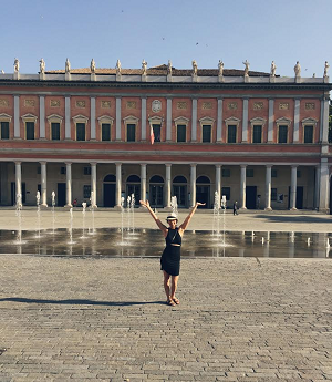 Woman in front a fountain in front of a building