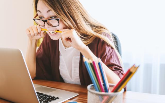 girl biting pencil