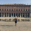 Woman in front a fountain in front of a building