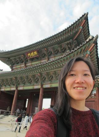 Student posing in front of a temple in South Korea